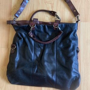 Used distressed black and dark brown leather bag